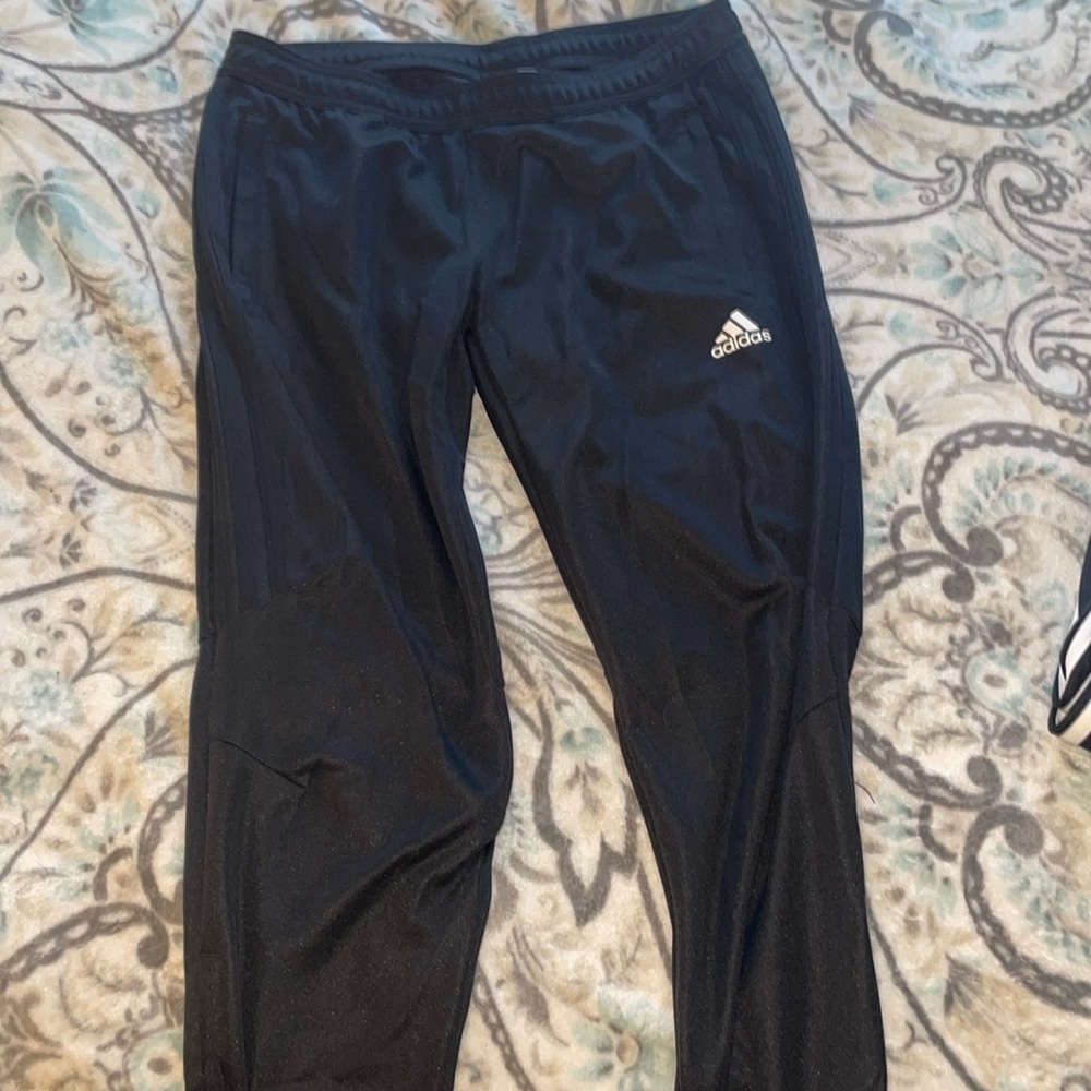 All black adidas joggers with lower leg zip